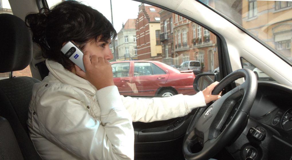 20070511, BRUSSELS, BELGIUM : Illustration picture shows a young woman driving while using her mobile phone (GSM), Friday 11 May 2007. In the south of Belgium, in Arlon, new King prosecutor said that the law allow the police to take away the object of a fault, here the mobile phone. So anybody who is caught using his mobile phone without a car kit while driving can see the phone taken by police. BELGA PHOTO HERWIG VERGULT
